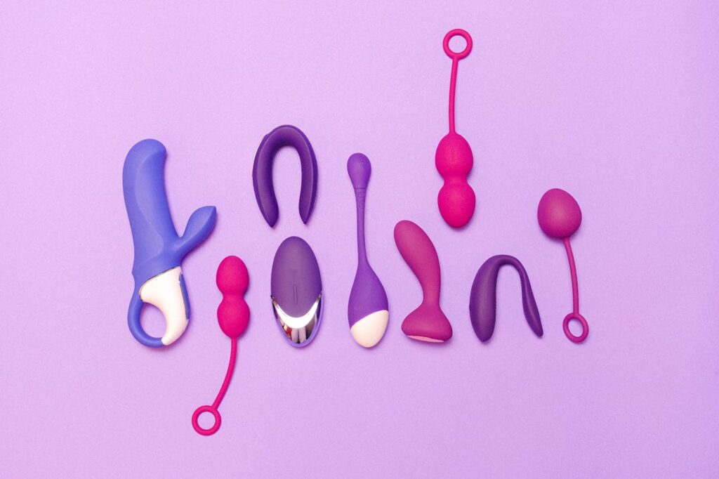 Various silicone sex toys displayed on a purple background for pleasure and education.